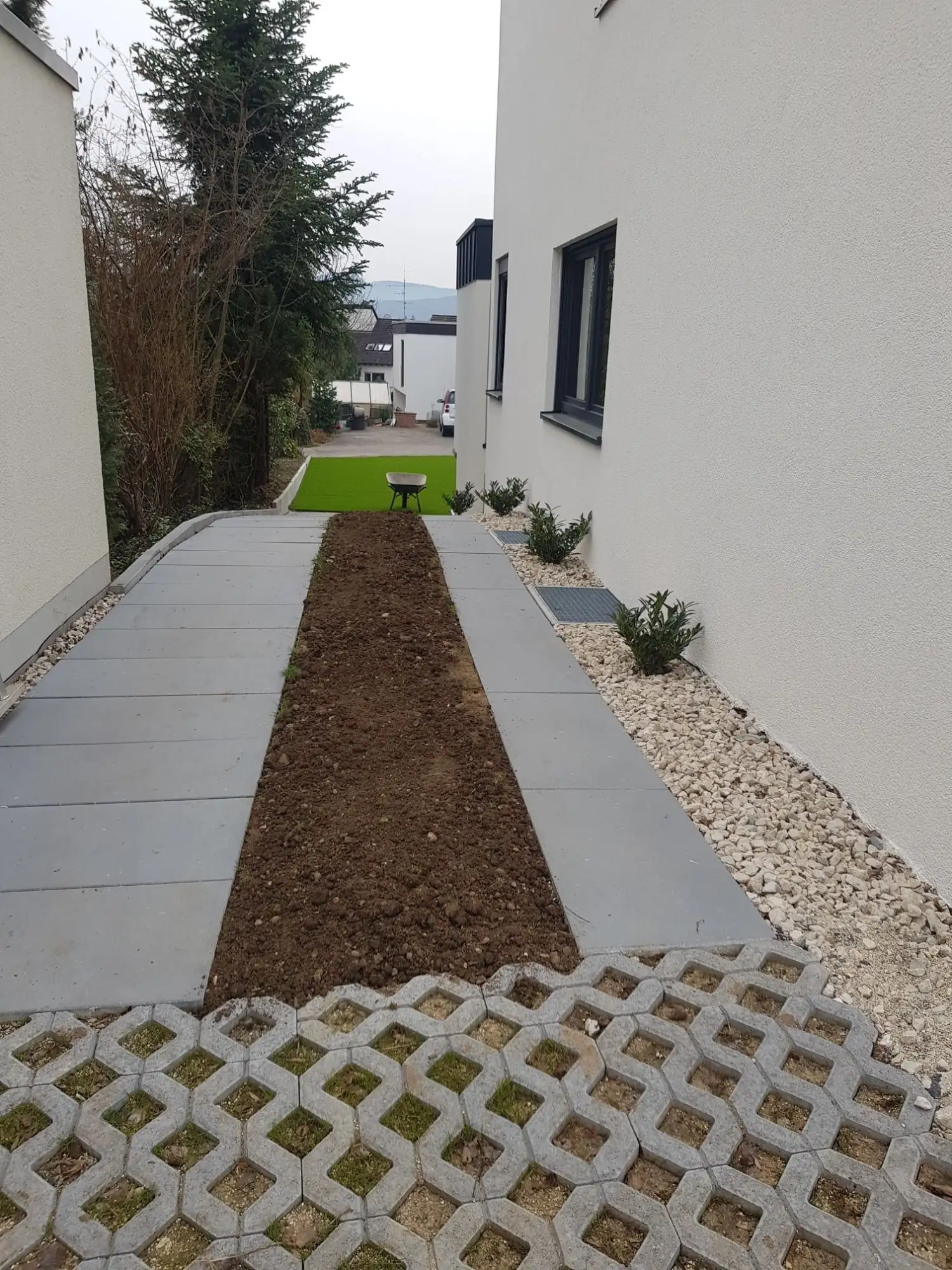 Seitenweg am Haus mit Rasengittersteinen und Pflanzstreifen